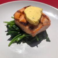 Salmon a la Parilla Dinner · Grilled salmon, sauteed spinach, herbed  butter.