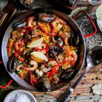 Paella del Dia Dinner · Traditional Spanish paella, with peas, shrimp, squid, mussels, chicken and chorizo with saff...