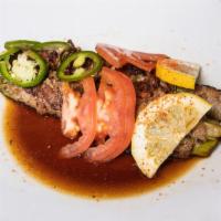 Beef Asparagus · Beef wrapped asparagus served in ponzu sauce topped with tomatoes.