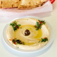 Hummus · Chickpeas, tahini, garlic, lemon and olive oil served with pita bread.