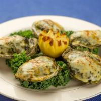Oysters Rockefeller · Topped with amaretto creamed spinach and melted provolone cheese. Gluten free.