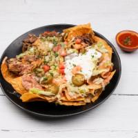 Nachos · Start with a bed of refried beans, tortilla chips topped with choice of shredded or ground b...