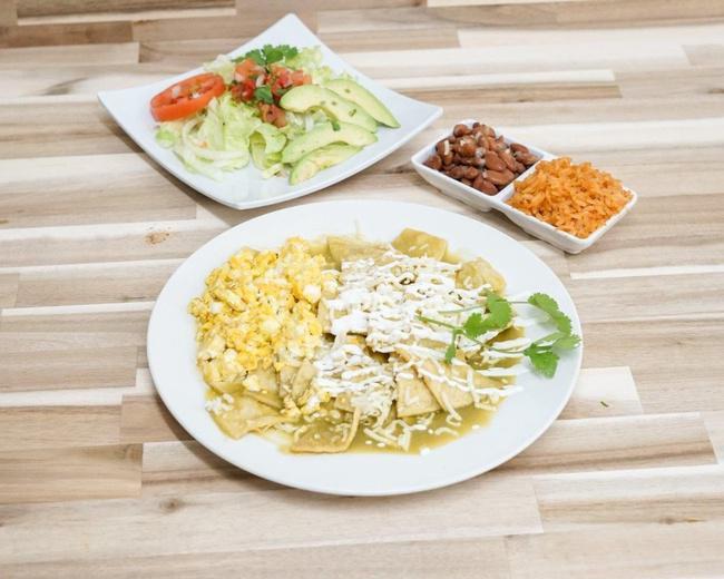 Chilaquiles · Scrambled or fried egg mixed with crispy tortilla strips and spicy salsa (red or green). Served with rice, beans, and salad.