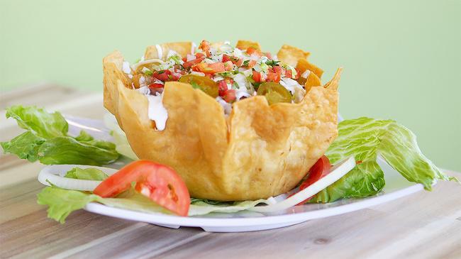 Taco Salad · Fried flour tortilla shell, meat, whole beans rice, lettuce, pico de gallo, avocado, and sour cream.