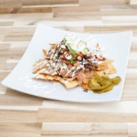 Nachos - Half · A half-size portion of our delicious nachos. House-made chips topped with your choice of mea...
