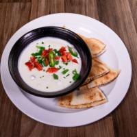 Signature Greek Tzatziki · A creamy yogurt dip with grated cucumbers, minced garlic, oregano and dried mint.