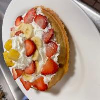 Tropical Belgian Waffle · Comes with bananas, fresh strawberries, pineapple, and whipped cream.