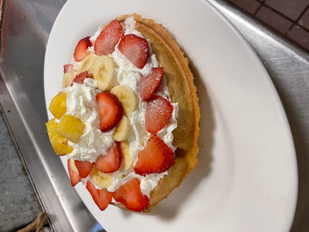 Tropical Belgian Waffle · Comes with bananas, fresh strawberries, pineapple, and whipped cream.
