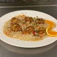 Jumbo Shrimp Scampi · Shrimp sauteed with garlic, white wine and lemon butter, served over rice.