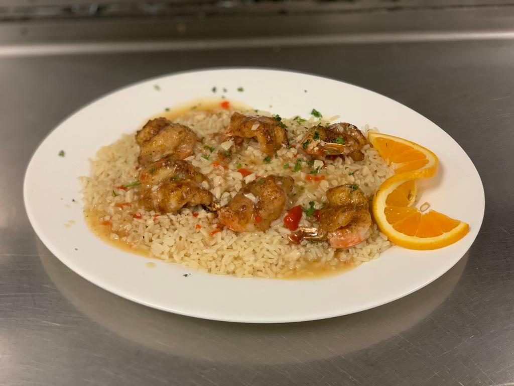 Jumbo Shrimp Scampi · Shrimp sauteed with garlic, white wine and lemon butter, served over rice.