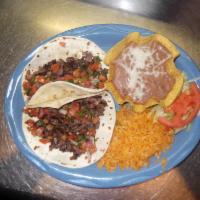 Tacos al Carbon · Three corn tortillas filled with your choice of skirt steak, chicken, pork carnitas or Al Pa...