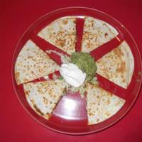 Quesadilla · A flour tortilla filled with cheese. tomatoes, and onions. Served with sour cream and guacam...