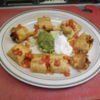 Chicken Taquitos · Two fried flour tortillas filled with chicken and Jack cheese topped, sour cream and guacamo...