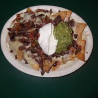 Super Nachos · Corn tortilla chips topped with melted cheese, refried beans, onions, and diced tomatoes.