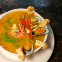 Sopon Marinero con Tostones Y Arroz Blanco · Seafood stew with shrimp, squid, shells, lobster and fish chunks. Comes with white rice and ...