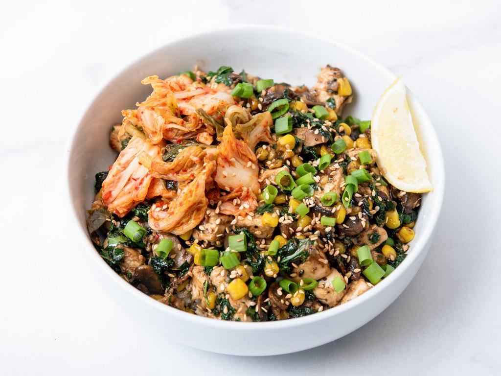 Sweet Chicken Kimchi Bowl · Antibiotic-free roasted chicken with kimchi, roasted corn, sauteed mushrooms, citrus-marinated kale, caramelized onions, green onions, sesame seeds, and our sweet Korean BBQ sauce. Served with a lemon wedge and a base of your choice. (gluten-free)        