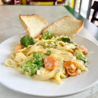 Broccoli Alfredo  · Fettuccine pasta in cream with fresh sautéed broccoli, carrot. Parmesan cheese added on top....