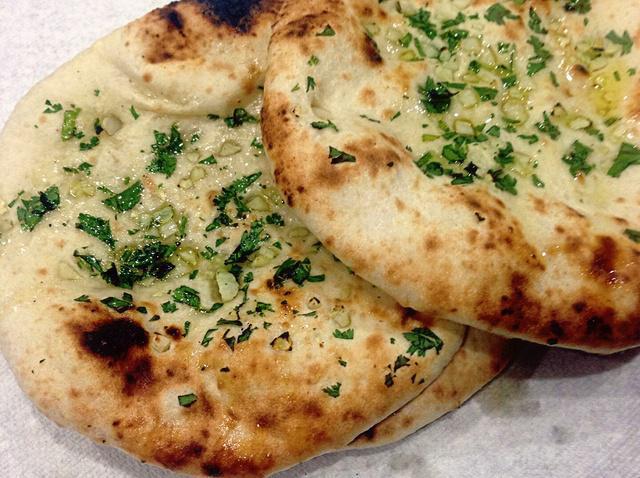 5. Garlic Naan · Leavened flour bread topped with fresh garlic.