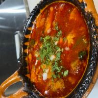 PANCITA · traditional Mexican soup made with beef stomach and cow foot in broth with a red guajillo sa...