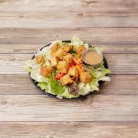 Green Salad · An assortment of fresh green salad vegetables and tofu, all dressed with peanut sauce.