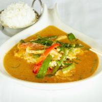 Panang Chicken · Creamy coconut milk cooked with panang curry and Thai herbs, string beans, red peppers, and ...