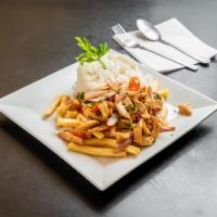 Pollo Saltado · Stir fried chicken pieces sauteed with onion and tomatoes. Served  with french fries and whi...