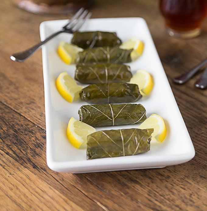 Dolma · Grape leaves stuffed with cilantro rice and served with tzatziki sauce. Vegetarian.