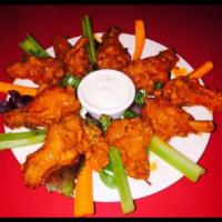 Buffalo Wings · Wings tossed in a tangy and spicy sauce served with ranch dressing, celery and carrot sticks.