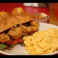 Shrimp Po' Boy Sandwich · Cornmeal-battered, fried tiger prawns, mixed greens, lettuce and tomatoes served on a toaste...