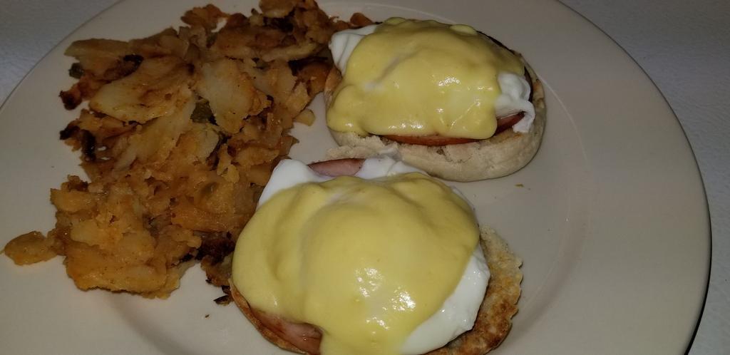 Eggs Benedict Breakfast · 2 poached eggs, Canadian bacon on English muffin topped with Hollandaise sauce. Served with potatoes