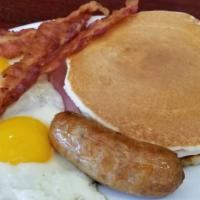 Pancakes Breakfast deluxe · 2 eggs any style with bacon, ham and sausage.