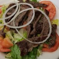 Grilled Steak Salad · Sliced steak served over spring mix, red cabbage, carrots and grape tomato.