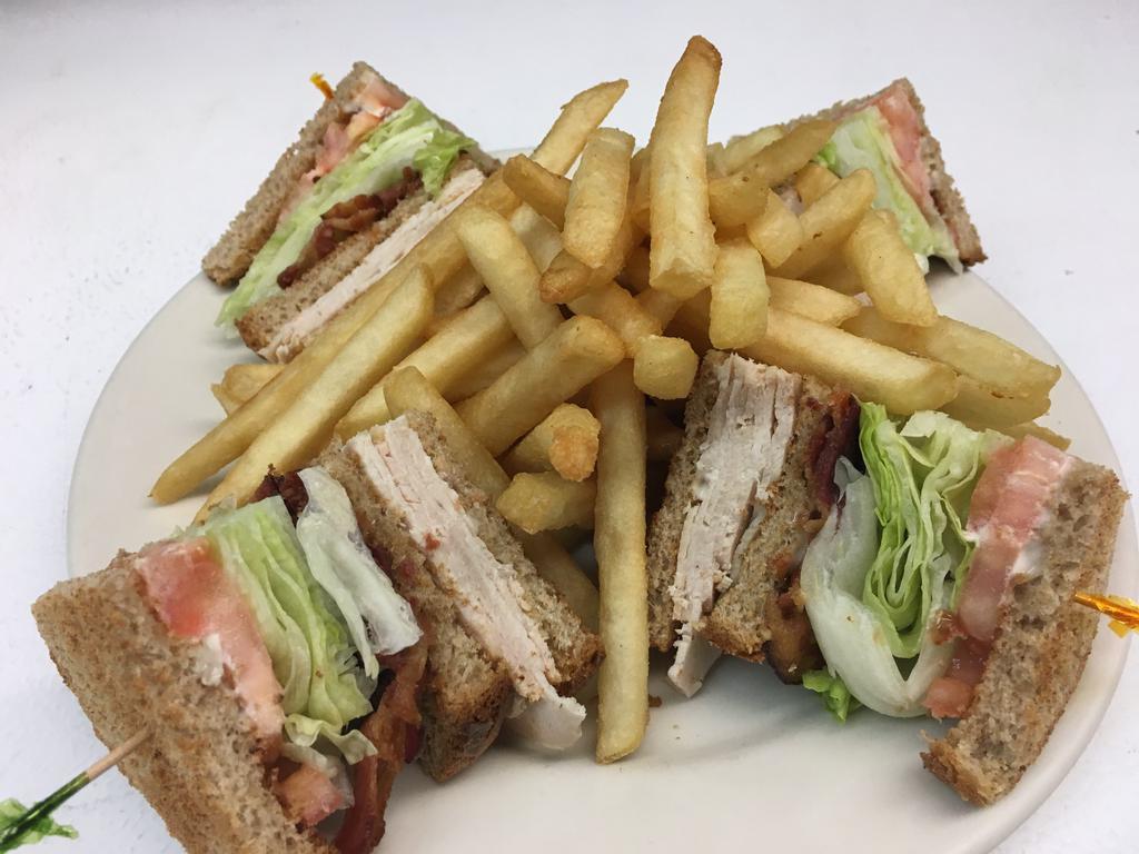 Turkey Club · Bacon, lettuce and tomato. Served with french fries, mayonnaise, coleslaw and pickle.