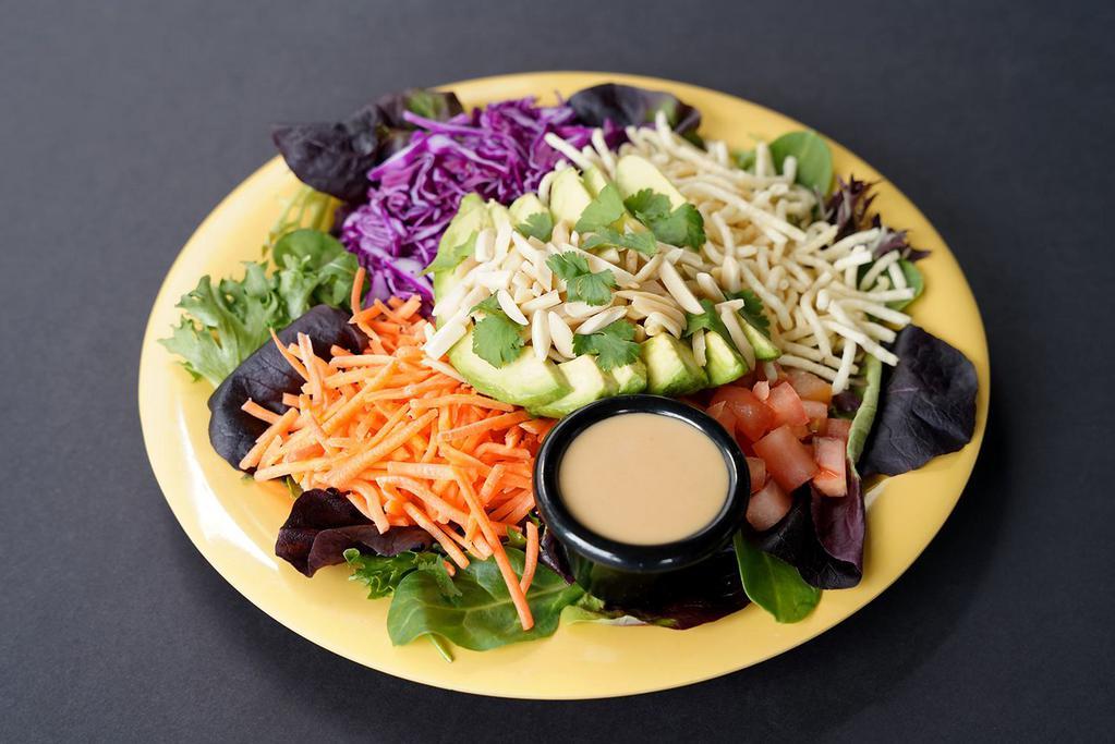 AvoCrunch Salad™ · Organic Field Greens, Tomato, Carrots, Red Cabbage, Crispy Noodles (GF), Sliced Avocado, Slivered Almonds, Cilantro, Sweet Ginger Miso Dressing.