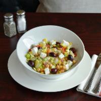 Chopped Greek Salad · Ripe tomatoes, cucumber, red onions, olives, feta cheese, roasted corn, chick peas, virgin o...