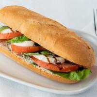 Caprese Sandwich · A freshly baked baguette loaf with a light coat of our labneh spread with generous slices of...