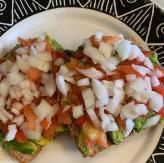 Avocado Toast  · Toasted multi grain with chopped tomatoes and onions ontop of avocado.