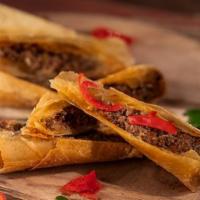 Cape Malay Samoosas - Lamb · Flaky pastry filled with spicy meat and cut into spears. Served with zesty green mamba sauce...