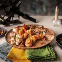Sandy Bay Seafood Platter · Sautéed Porto shrimp and scallops on fragrant South African rice, wood-grilled calamari and ...