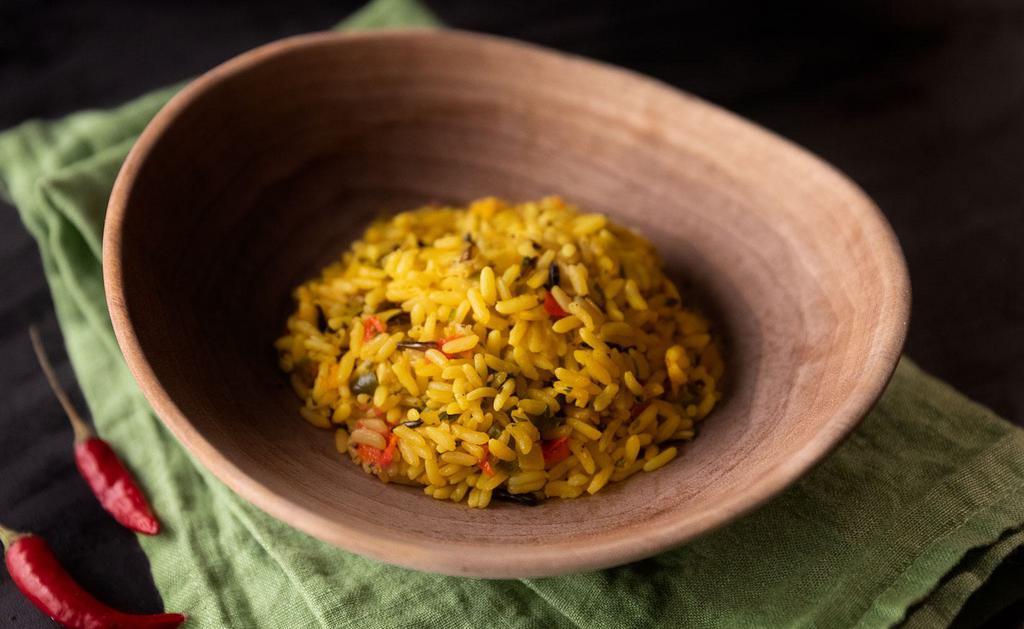 Fragrant Rice · South African-style long grain and wild rice with corn, bell peppers, cilantro and onions seasoned with turmeric and South African herbs.
