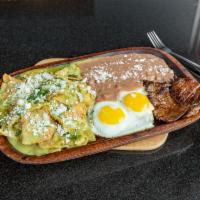 Chilaquiles Verdes Con Epazote · Squared strips of fried corn tortillas, smothered with green sauce and epazote. Topped off w...
