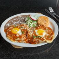 Huevos Rancheros · Served with rice and beans. Wo over easy eggs, placed over two fried handmade corn tortillas...
