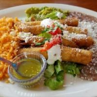 Taquitos de Pollo · Served with rice and beans. Four corn tortillas rolled, fried and filled with chicken. Serve...