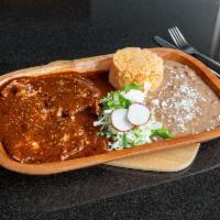 Mole Burrito · Burrito filled with chunks of chicken, rice and beans, smothered in a rice mole poblano sauc...