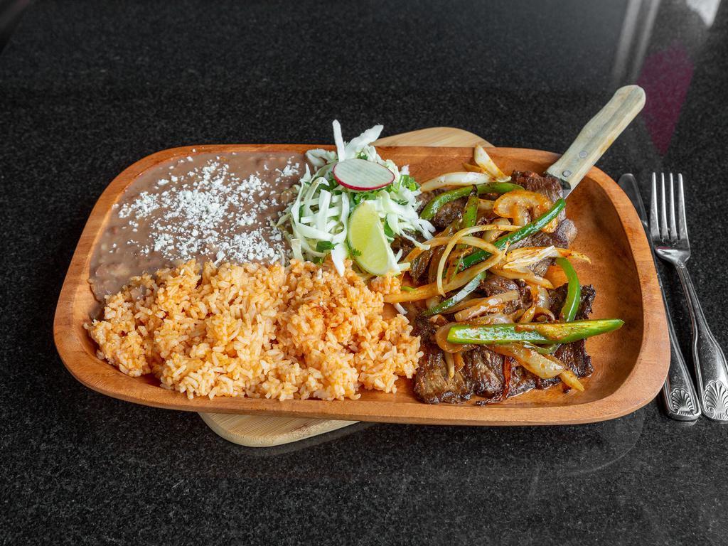 Carne Arrachera · Served with rice, beans and hand made tortillas. Flat iron steak marinated in Morita peppers, lime juice, fresh garlic and grilled with onions and chili pepper and comes with a corn quesadilla.