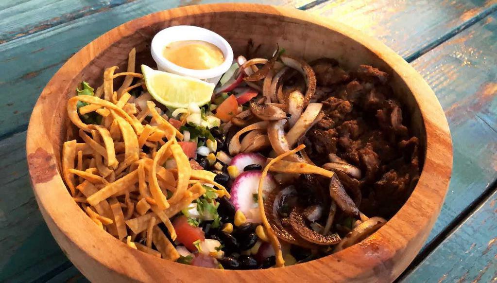 Ensalada Santa Fe · Chef’s choice of fresh greens, grilled chopped steak, tomatoes, black beans, corn, cilantro, grilled balsamic onions, tortilla strips and lime wedges, with chipotle and cilantro dressing.