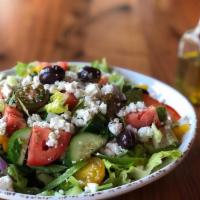 Greek Salad · Romaine hearts lettuce, tomatoes, cucumbers, onions, peppers, tossed in our house dressing, ...
