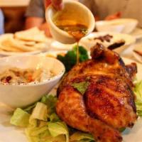 Spicy Garlic Chicken Plate · Half rotisserie chicken made with our house-made spicy garlic lemon sauce, served on a bed o...