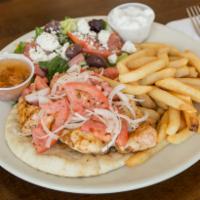 Chicken Souvlaki Platter · Broiled chunks of chicken on a toasted pita with onions and tomatoes, served with greek sala...