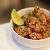 Chicken Wings  · Crispy wings tossed in a brown butter honey sauce OR spicy red chile hot sauce